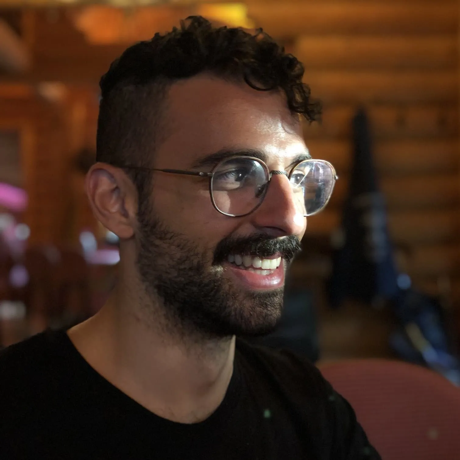 Alejandro Tlaie Boria, smiling, wearing glasses and a black T-shirt
