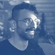 Alejandro Tlaie Boria, smiling, wearing glasses and a black T-shirt